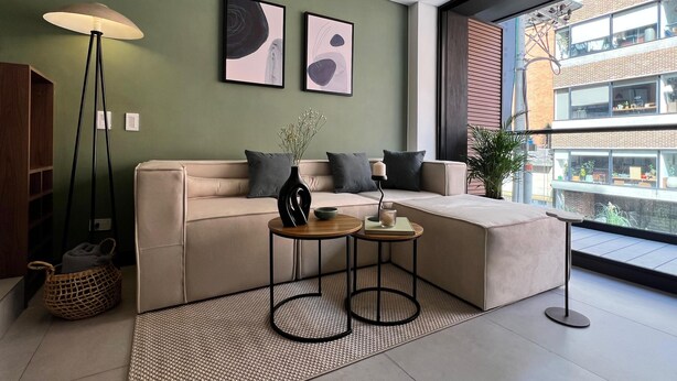 A modern living room with a beige sofa, two side tables, a floor lamp, and artwork on the wall. - Parque el Virrey modern & luxury apartment (Bogotá)