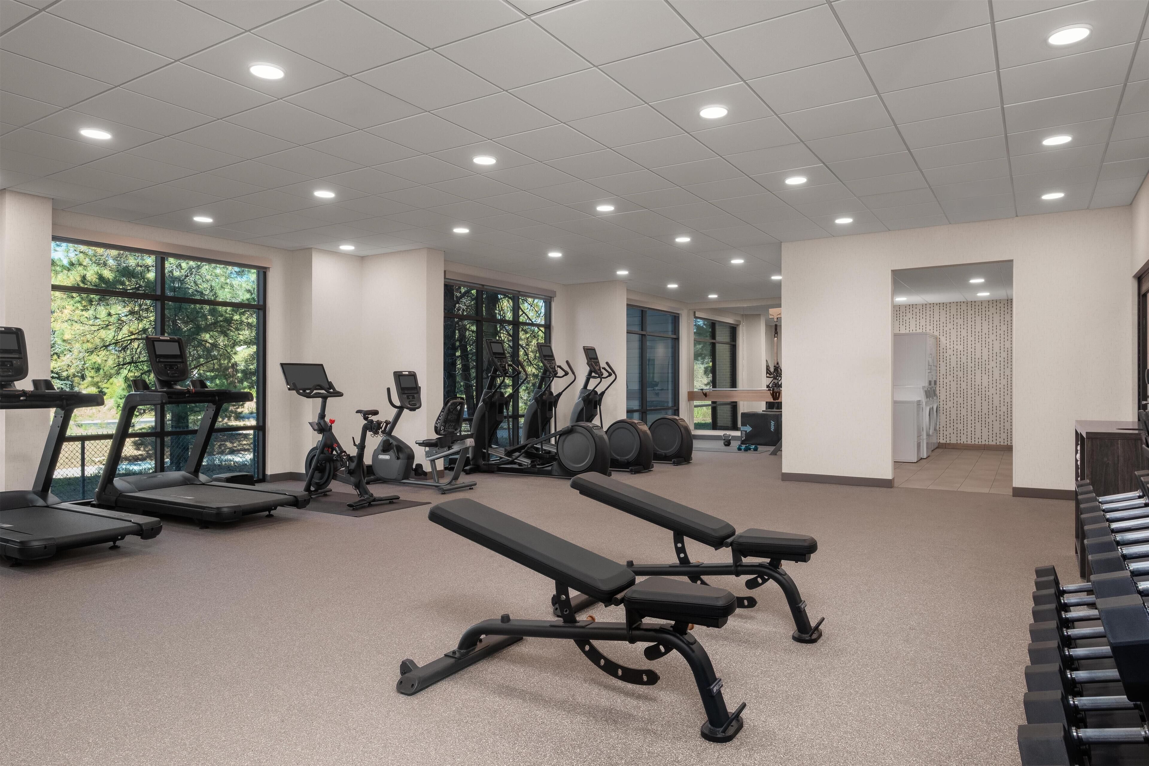 A gym with treadmills, stationary bikes, and weight machines.
