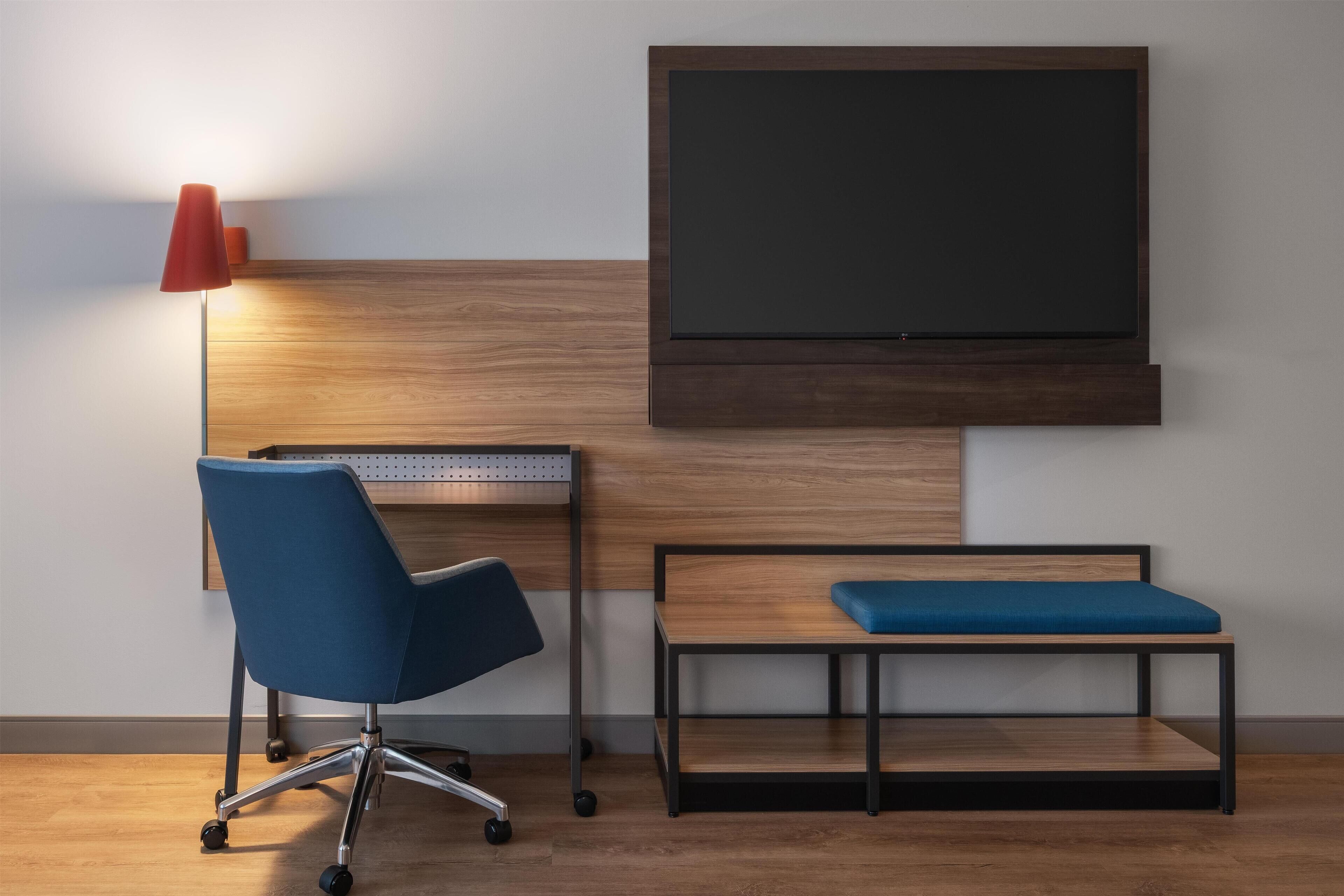 Hypo-allergenic bedding, desk, laptop workspace, blackout drapes