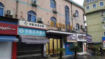 A building with multiple storefronts, including a sports club and a communication service.
