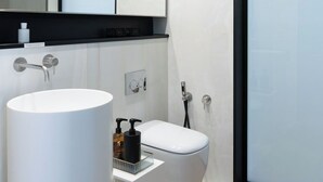 A modern bathroom with a large white sink, a toilet, and a shower. - Penthouse apartment 5.BMORE (Milano)