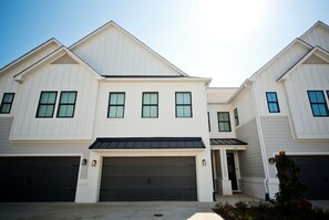 A two-story residential building with a garage, a covered entryway, and a small porch area. - Luxurious Property in the Heart of Oxford (Oxford)