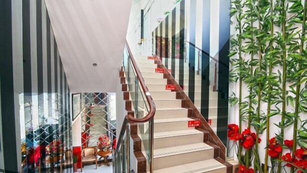A staircase with a glass railing and red signage, leading to a room with a view of a balcony. - Xiangfu Hostel (Shanghai Wuning Road) (Shanghai)