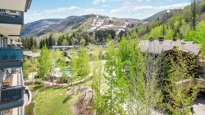 A residential area with a view of a ski resort, including a ski lift and buildings with balconies overlooking the landscape. - Lodge Tower 599 1BR  at the base of Vail Mountain (Vail)