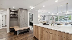 A modern kitchen with a large island, built-in shelving, and pendant lighting. - Lodge Tower 278 1BR at the base of Vail Mountain (Vail)