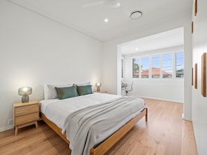 Cozy retreat with a single bed, bedside tables, and lamps.