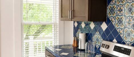 A kitchen with a stove, oven, and cabinets.