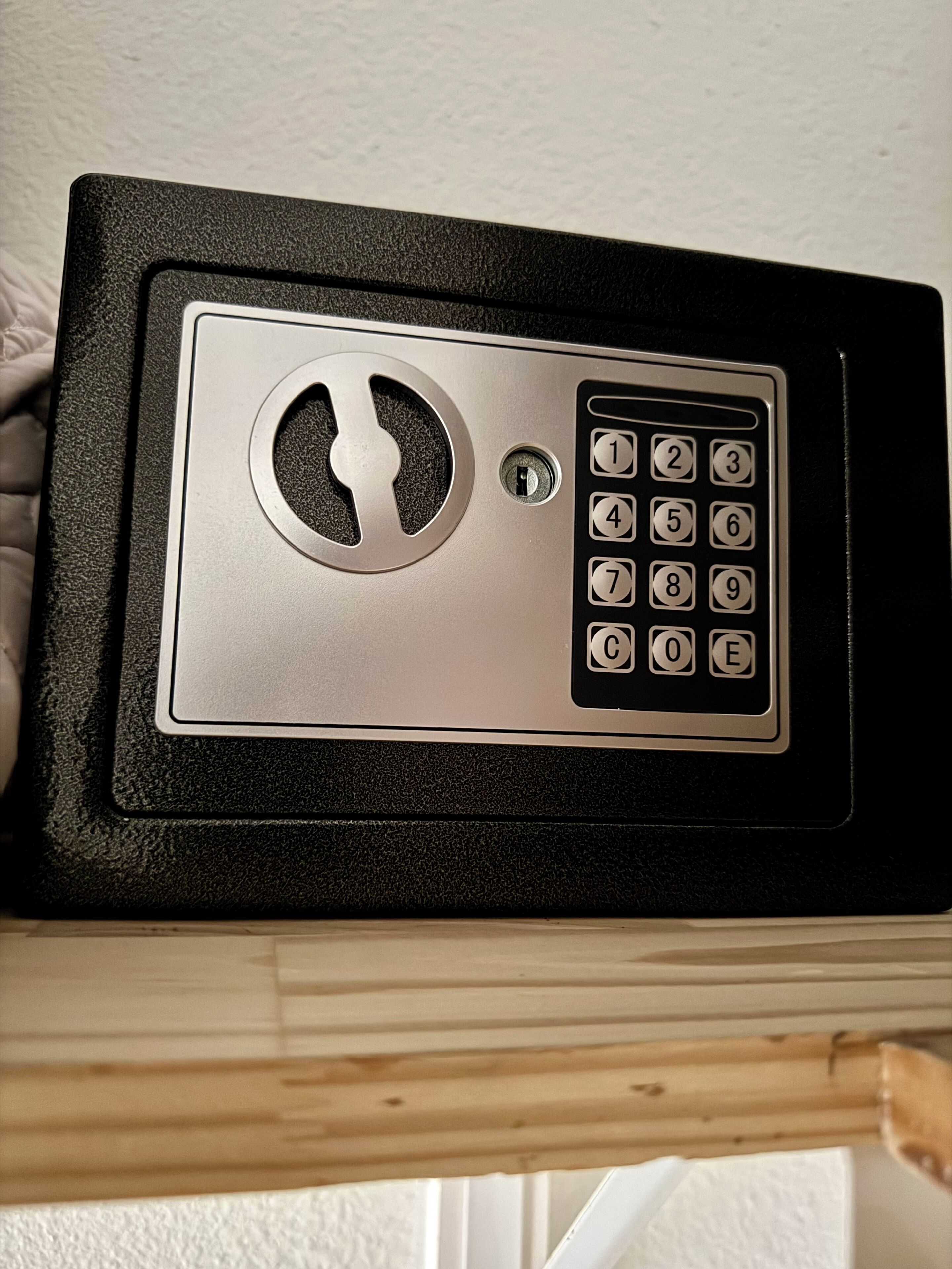 A black and silver electronic keypad lock on a door.