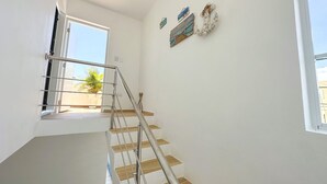 A staircase with metal railings leading to an open balcony. - Cape Coral 1 (Cabrera)