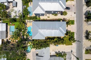 A residential area with multiple houses, a swimming pool, and a street. - Island Dream (Anna Maria)