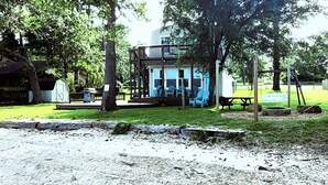 A cabin with a deck, outdoor seating, and a fire pit. - Lakeside Cabin With Your Own Personal Beach and Expansive Lake View (Point Blank)