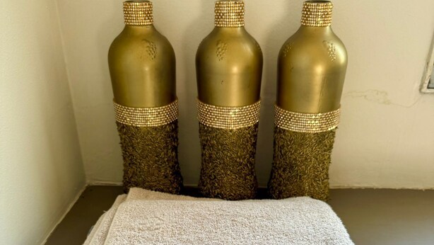 Three decorative vases with a textured pattern and a gold trim, placed on a flat surface. - Samurai sword apartment: Oriental decoration  (Amambai)