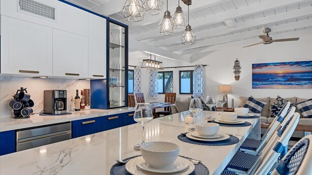 A modern kitchen with a long island, built-in appliances, and pendant lighting. - Charming spacious 3-bedroom house walking minutes from Siesta Key Beach (Siesta Key)