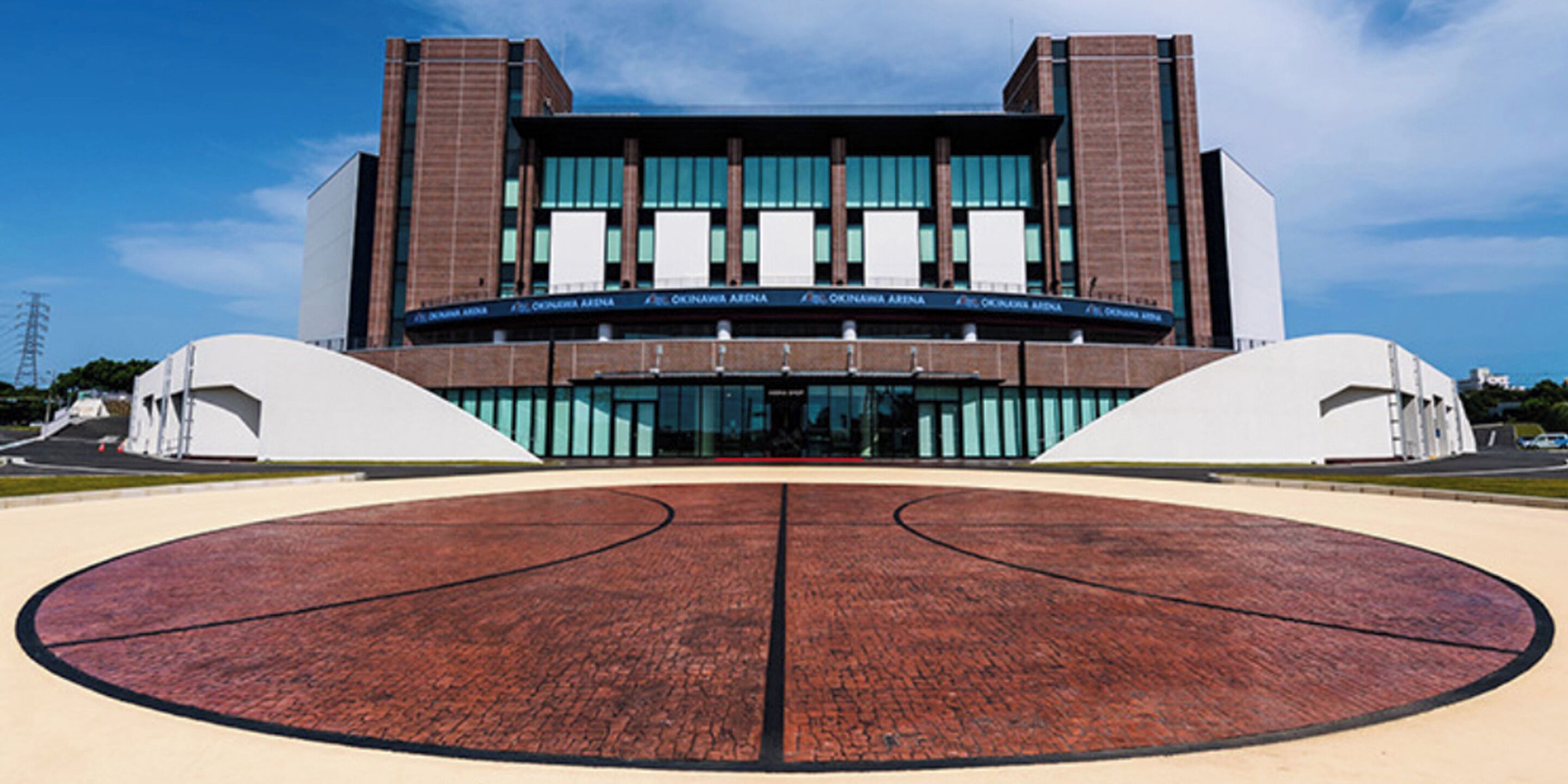 A modern building with a central courtyard featuring a basketball court.