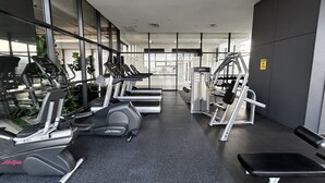A gym with treadmills, weight machines, and a bench. - Food Paradise Georgetown 218 Macalister 2BR Family Suite By Smart Space Home (George Town)