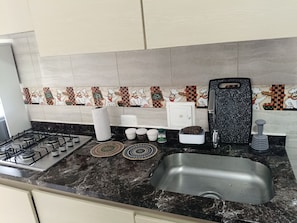 Fridge, microwave, stovetop, coffee/tea maker