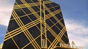 A modern building with a geometric facade and the name "PAHIR HOTEL" visible. - Fahira Hotel Syariah Padang (Padang)