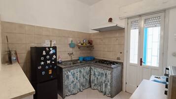 Fridge, coffee/tea maker, cookware/dishes/utensils, dining tables