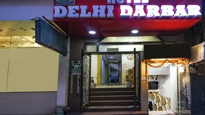 The entrance to Hotel Delhi Darbar with a sign above the door and a staircase leading inside. - Fabhotel Delhi Darbar (New Delhi)