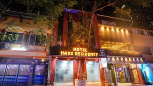 Hotel Hans Residency with a prominent neon sign, a traditional entrance, and a modern building adjacent to it. - Fabhotel Hans Residency (Mumbai)