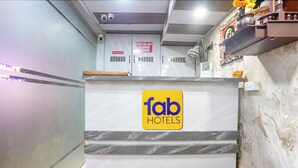 A reception desk with a 'fab hotels' sign, a 'visitor not allowed' sign, and a QR code on the wall. - Fabhotel Hans Residency (Mumbai)