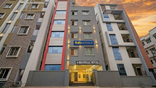 A multi-story hotel building with a prominent 'fabHOTELS' sign on the facade. - Fabhotel Aig Broholic (Hyderabad)