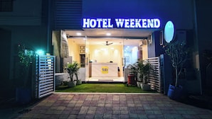 A hotel entrance with a neon sign reading "HOTEL WEEKEND". - Fabhotel Weekend (Indore)
