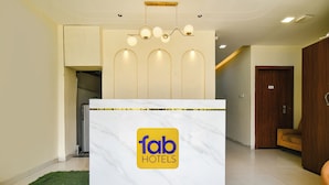 A reception desk with a marble top and a logo for 'fab hotels'. - Fabhotel Weekend (Indore)