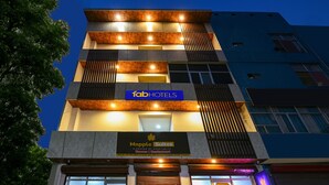 Een hotel met een bordje waarop 'Maple Suites' en 'FabHotels' staan.