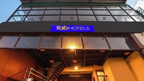 A building with a sign reading "fabHOTELS" and a staircase leading to an entrance. - Fabhotel Lloyd’S Inn (Chennai)