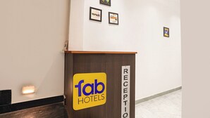 A reception area with a sign for 'fab hotels' and a 'RECEPTION' sign on the wall. - Fabhotel The Shivaay Palace (Varanasi)