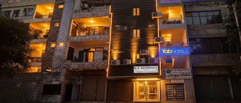 A multi-story building with a sign for 'N.K. Residency' and 'Tab Hotels'.
