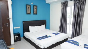 A hotel room with a large bed, a bedside table with a phone, and a window with curtains. - Hotel Shri Putiri (Pasir Gudang)