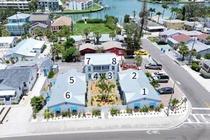 A residential area with numbered houses, a marina, and a road with a bike lane. - Getaway to a Courtyard View, Walk to Beach & Shops, Kitchen & Tickets Included to Top Attractions. (Treasure Island)