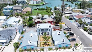 A residential area with numbered houses, a marina, and a road with a bike lane.