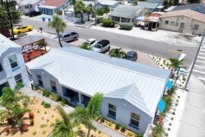 A modern two-story building with a flat roof and large windows.