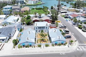 A residential area with numbered houses, a marina, and a road with a bike lane.
