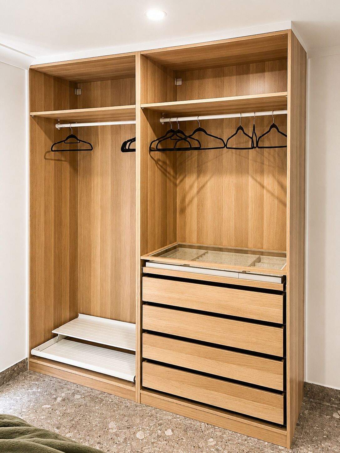A wooden wardrobe with multiple compartments, including hanging space and drawers.