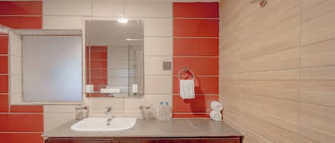 A bathroom with a sink, mirror, and wooden wall paneling.