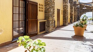 A building with a stone facade, a wooden door, and a potted plant.