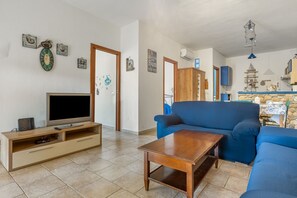 Living area - GuestHost - Cozy 70 sqm apartment with private parking space; accommodates up to 4 people plus camping cot on request.The courtyard is covered and privateWe are located in a renowned tourist resort on the Gulf of Cagliari.The accommodation consists of tw (Cagliari)