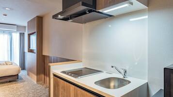 A modern kitchen with a built-in stove, a sink, and a compact countertop.