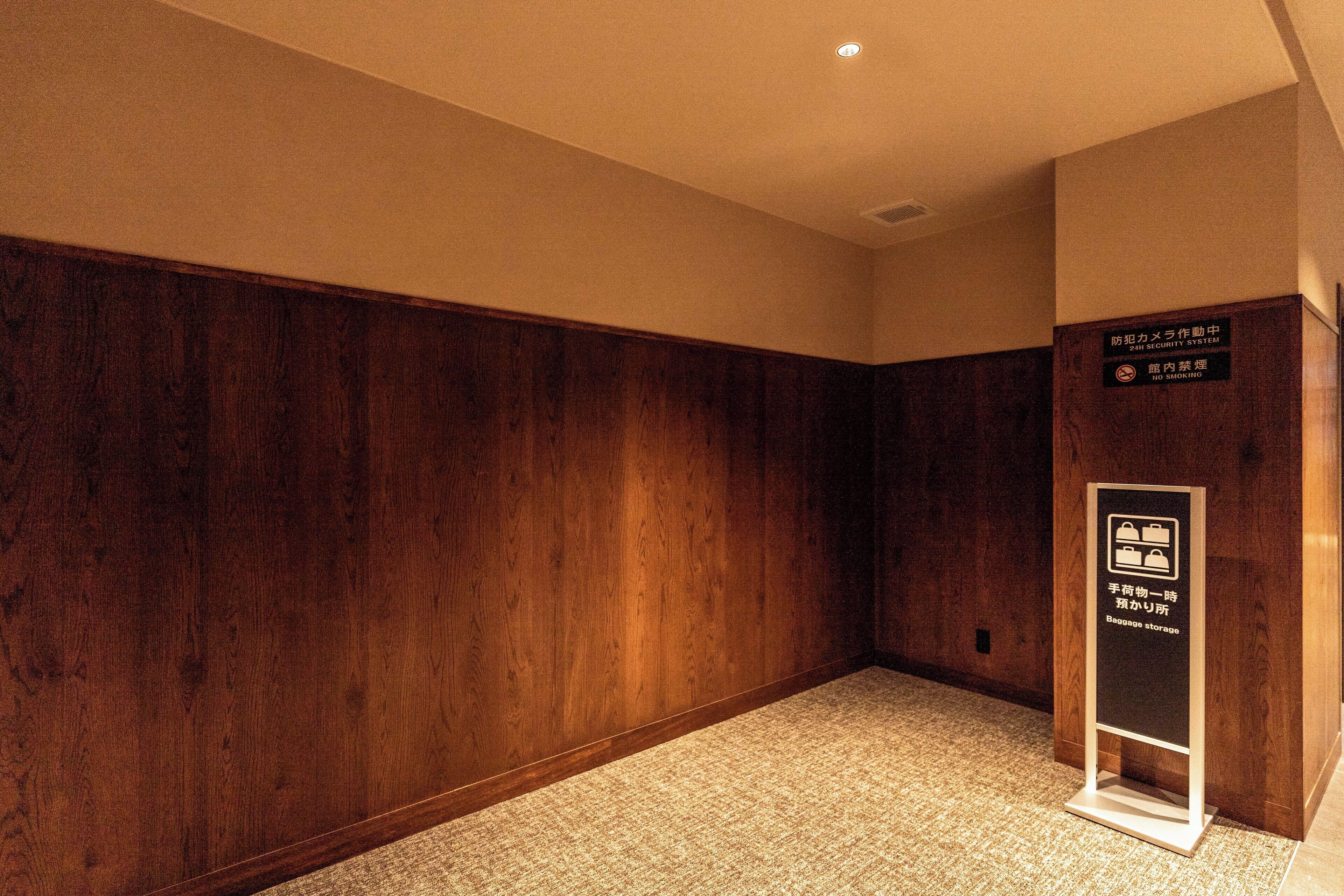 A hallway with wooden paneling and a security system sign.