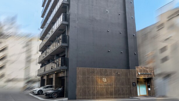 A tall, modern building with a sign reading "APARTMENT HOTEL." It features multiple balconies and a large entrance. - Apartment Hotel 11 Nippombashi (Osaka)