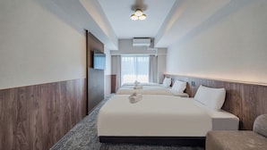 A hotel room with two beds, a flat-screen TV, an air conditioning unit, and a view of the outdoors. - Apartment Hotel 11 Nippombashi (Osaka)