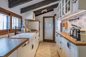 Enjoy cooking in this well-equipped kitchen with a central island, oven, and ample countertop space.