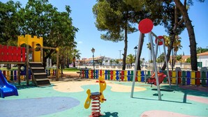 A playground with a slide, climbing structures, and a spring-mounted toy. - Artesol 4 pax in Platja de l Arenal (Els Poblets)