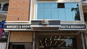 A hotel named "RIGS CRYSTAL" with a sign indicating "BANQUET & ROOMS" and "WEETS & RESTAURANT" below. - Hotel RGS Crystal (Kanpur)
