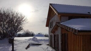 A wooden building with a snow-covered roof and a snow-covered ground. - Gîte 'Les Ursules', sleeps 2 to 6 (Le Barboux)