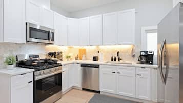 Fridge, microwave, coffee/tea maker, cookware/dishes/utensils